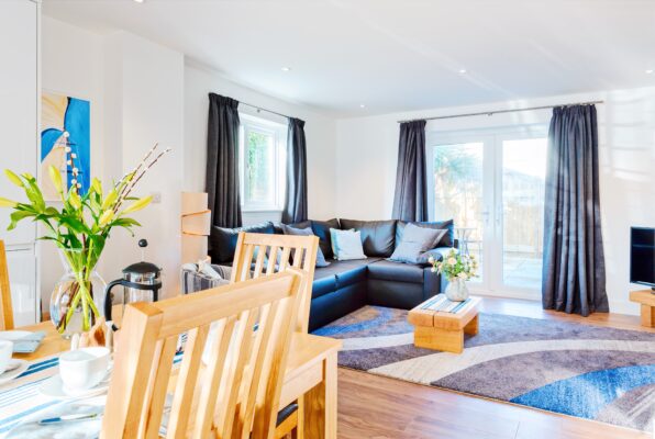 Cosy Fistral Palms 2 lounge, complete with fresh lilies. Located on the Pentire Headland in Newquay, Cornwall